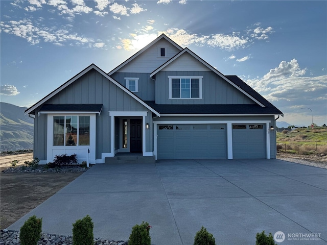 craftsman-style home with an attached garage, board and batten siding, and driveway