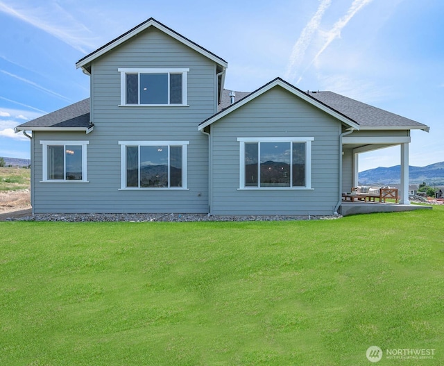 1502 S Kelvin Ct, East Wenatchee, WA 98802 - rear view of property featuring a lawn, a mountain view, and a shingled roof