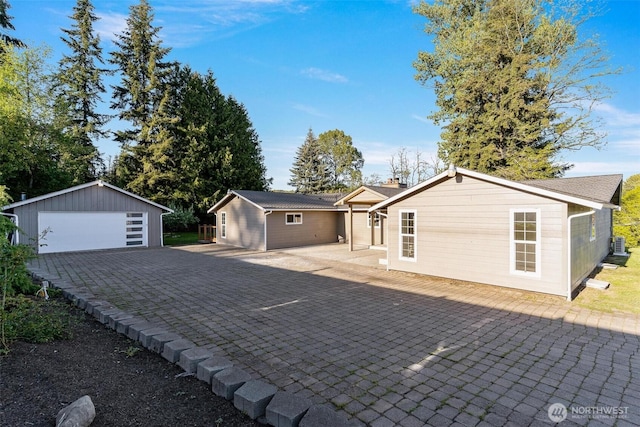 view of front of property featuring an outbuilding and a garage