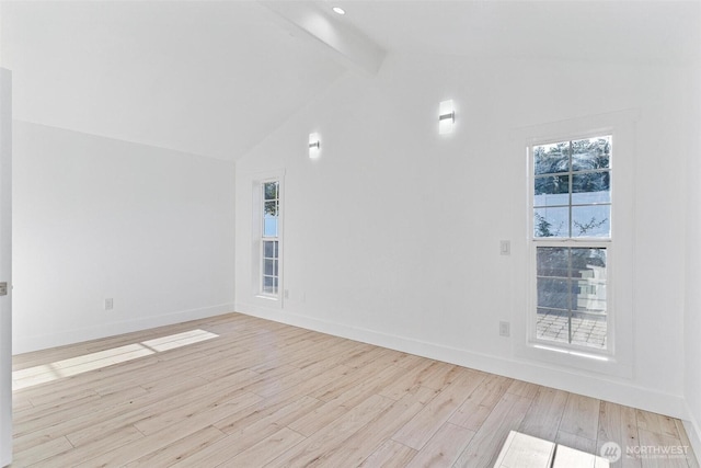 spare room featuring wood finished floors, baseboards, and lofted ceiling with beams