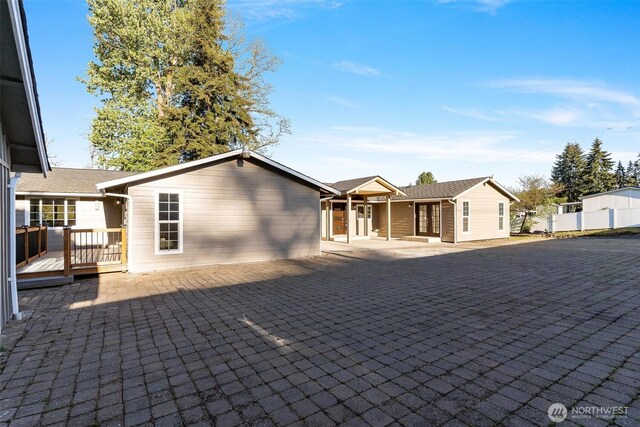 view of front of house with french doors and a deck