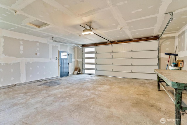garage with electric panel and a garage door opener