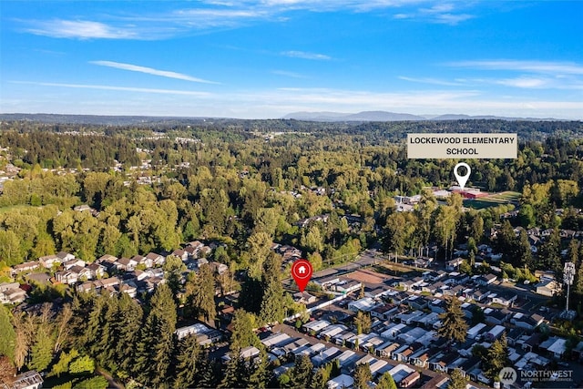 aerial view featuring a mountain view, a forest view, and a residential view