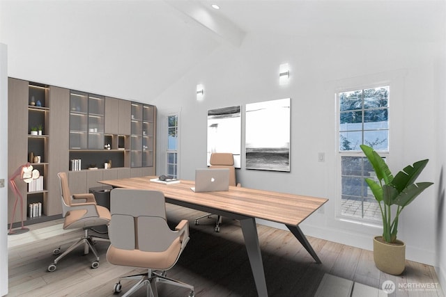 home office with light wood finished floors, beam ceiling, baseboards, and high vaulted ceiling