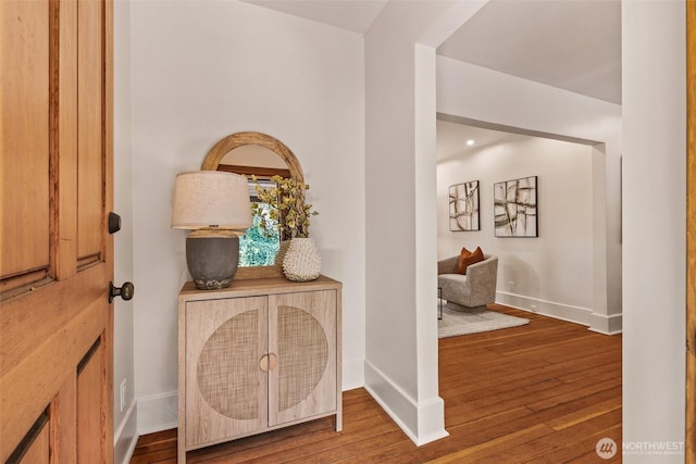 entrance foyer featuring baseboards and hardwood / wood-style floors