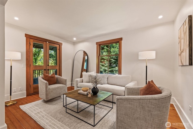 living area featuring baseboards, recessed lighting, and wood finished floors