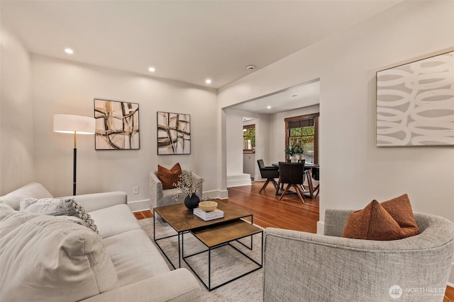living area with recessed lighting, baseboards, and wood finished floors