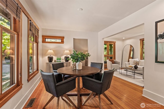 dining area featuring visible vents, baseboards, a wealth of natural light, and wood-type flooring
