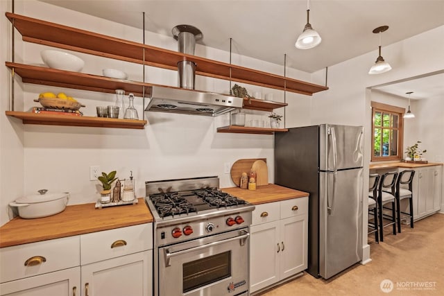 kitchen featuring open shelves, appliances with stainless steel finishes, and wooden counters