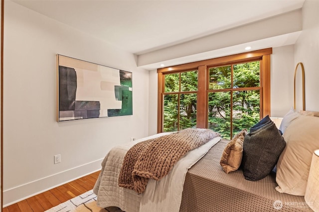 bedroom with recessed lighting, baseboards, and wood finished floors