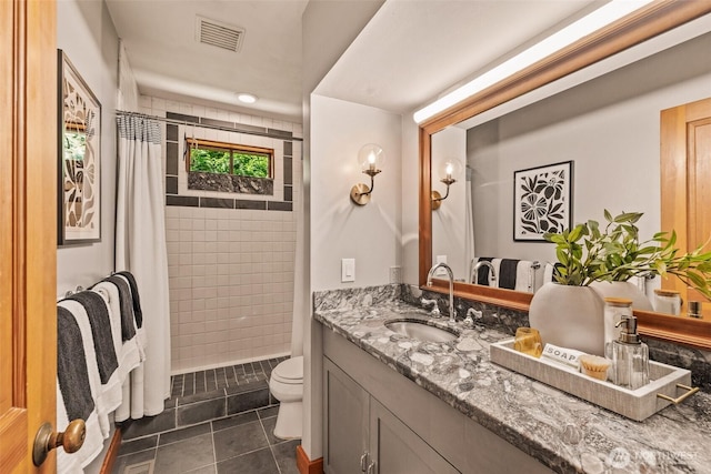 bathroom with visible vents, tile patterned flooring, vanity, toilet, and a shower stall