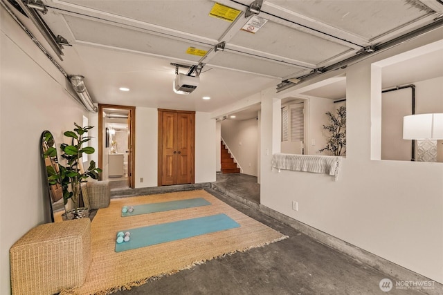 garage with recessed lighting and a garage door opener