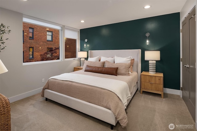 bedroom with baseboards, recessed lighting, and light carpet
