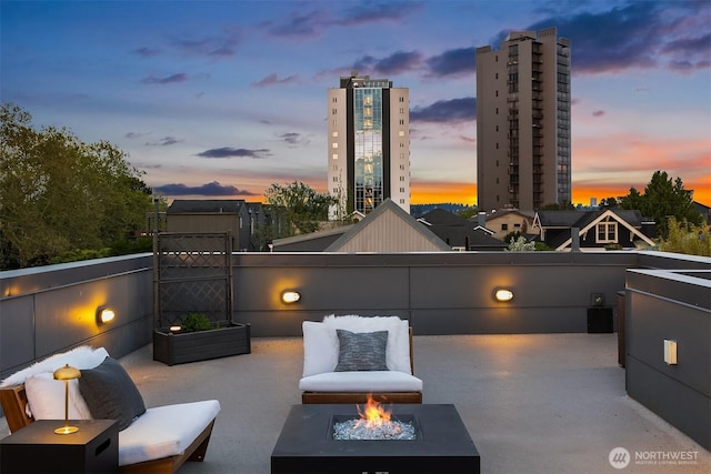patio terrace at dusk with an outdoor fire pit