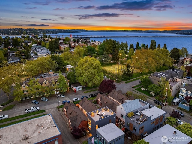 drone / aerial view featuring a water view and a residential view