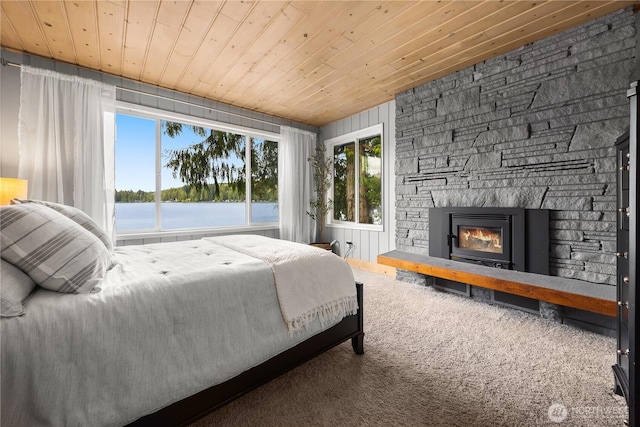 23821 S Lake Roesiger Rd, Snohomish, WA 98290 - carpeted bedroom featuring wood ceiling, a fireplace, and a water view
