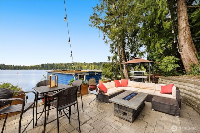 23821 S Lake Roesiger Rd, Snohomish, WA 98290 - view of patio featuring a gazebo, an outdoor living space with a fire pit, outdoor dining area, a water view, and a grill