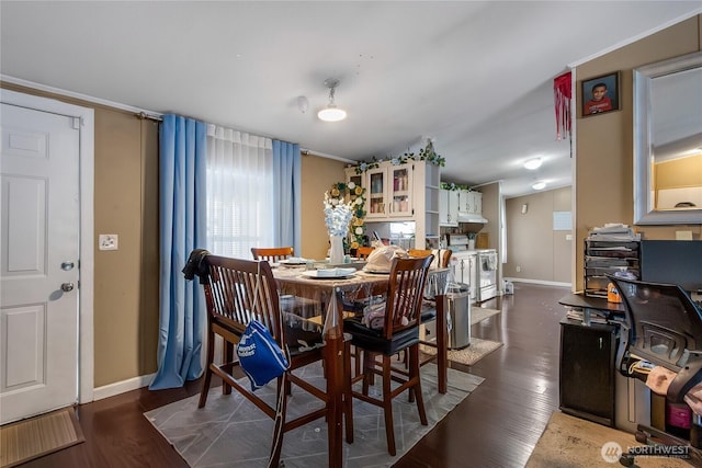 dining area featuring baseboards and wood finished floors