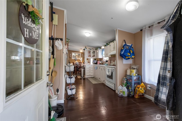kitchen featuring white cabinets, light countertops, white range with electric cooktop, baseboards, and dark wood-style floors