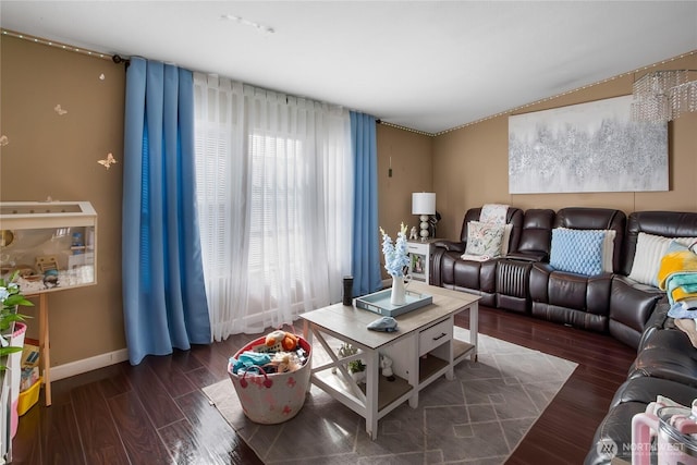 living area featuring baseboards and wood finished floors