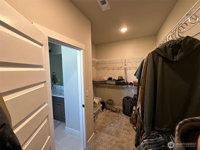 walk in closet featuring carpet flooring and visible vents