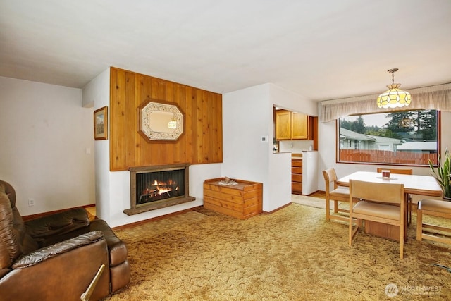 4995 Johnson St NW, Bremerton, WA 98311 - dining room with a lit fireplace, light carpet, and baseboards