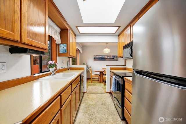 4995 Johnson St NW, Bremerton, WA 98311 - kitchen featuring black appliances, a sink, brown cabinets, light countertops, and hanging light fixtures