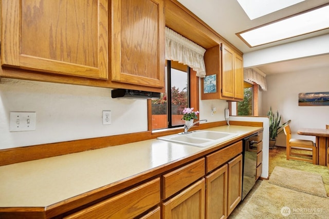 4995 Johnson St NW, Bremerton, WA 98311 - kitchen with a sink, light countertops, light carpet, black dishwasher, and a skylight