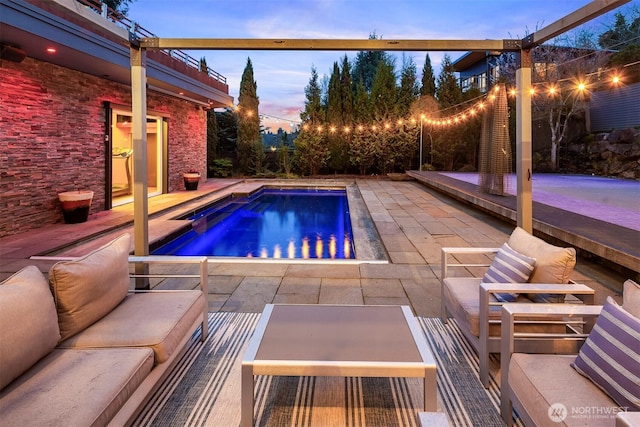 pool featuring a hot tub and a patio