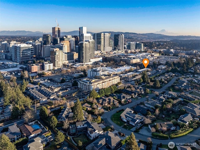 drone / aerial view featuring a view of city and a mountain view