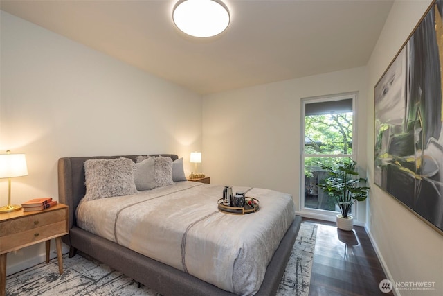 bedroom featuring baseboards and wood finished floors