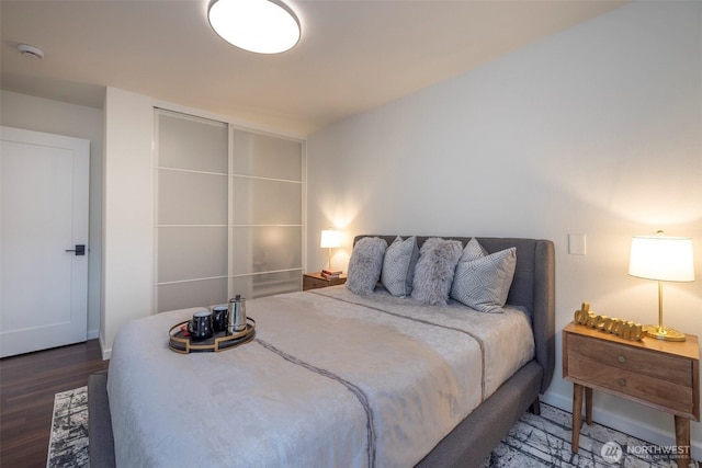 bedroom featuring baseboards and wood finished floors