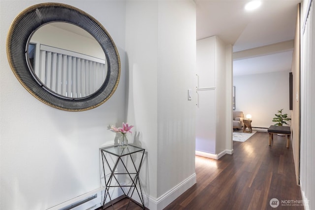 hallway with dark wood-style flooring, baseboards, a baseboard heating unit, and recessed lighting