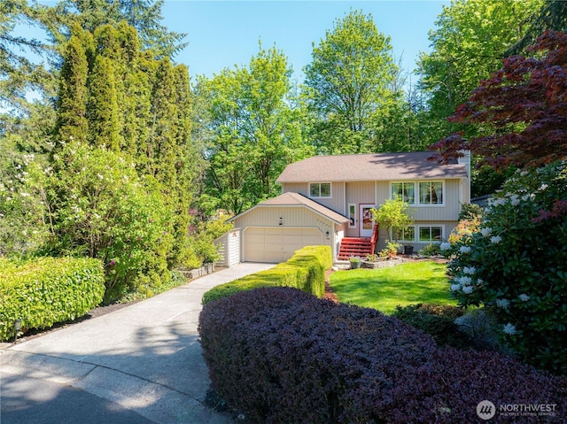 split foyer home featuring an attached garage and driveway