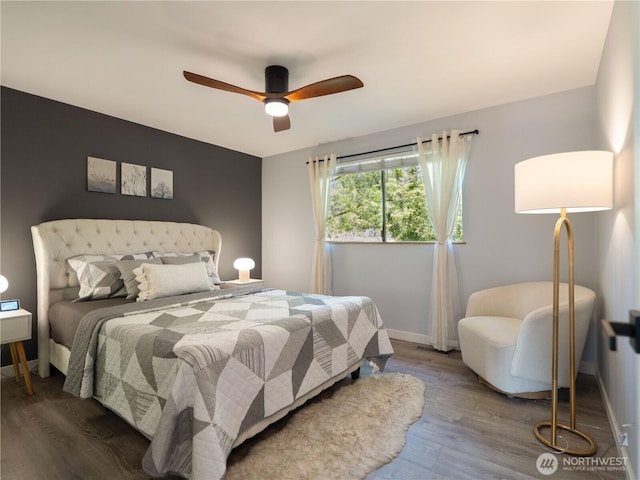 bedroom with baseboards, a ceiling fan, and wood finished floors