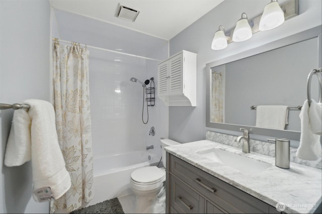 bathroom featuring toilet, visible vents, shower / tub combo, and vanity