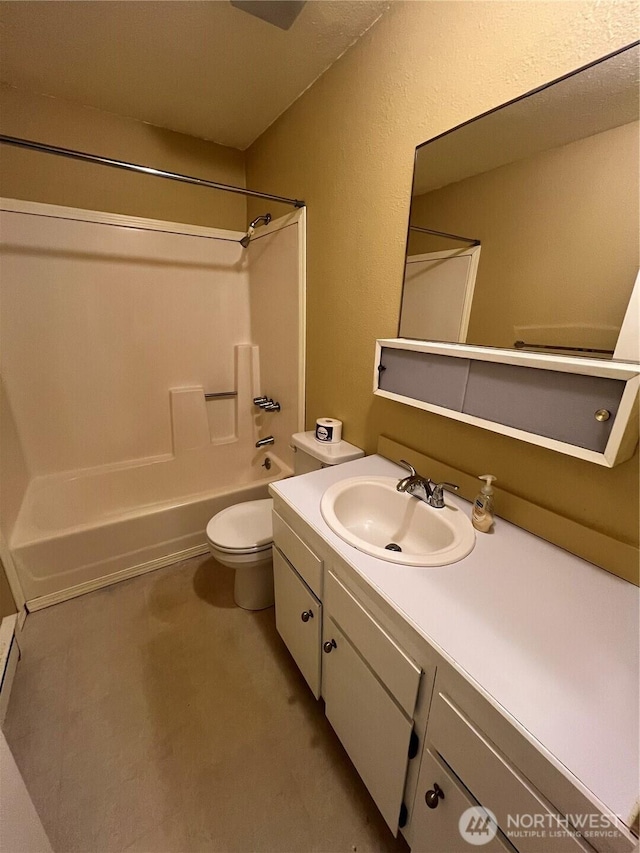 full bath with vanity, a textured wall, tub / shower combination, and toilet