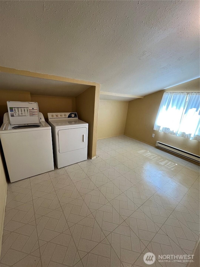 washroom with washing machine and clothes dryer, a textured ceiling, laundry area, and baseboard heating