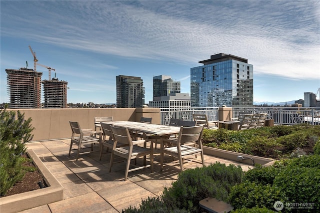 819 Virginia Unit 1104, Seattle, WA 98101 - view of patio with outdoor dining space and a city view