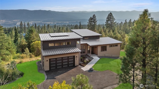 view of front of property featuring a standing seam roof, solar panels, metal roof, and a front yard