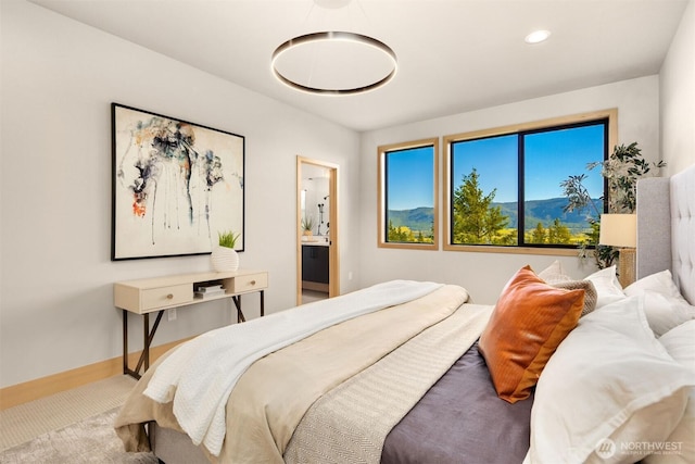 bedroom with carpet floors, recessed lighting, baseboards, and ensuite bath