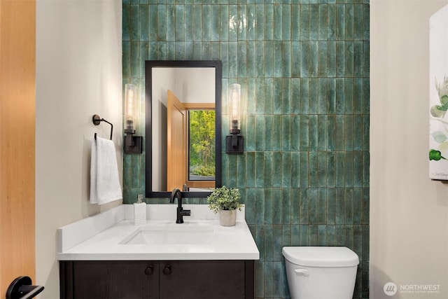 bathroom featuring vanity and toilet