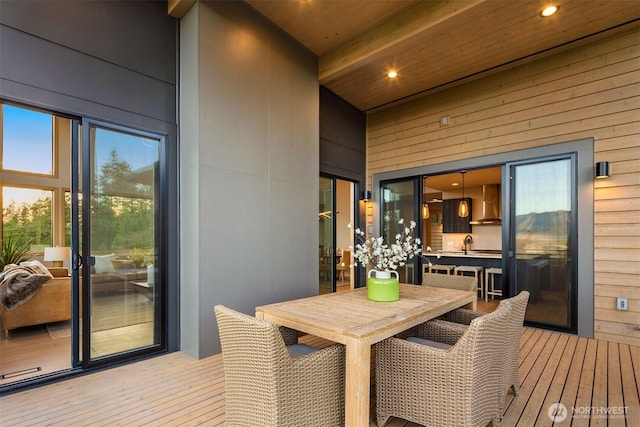 wooden terrace featuring outdoor dining area