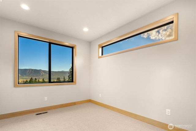 empty room featuring recessed lighting, baseboards, visible vents, and carpet