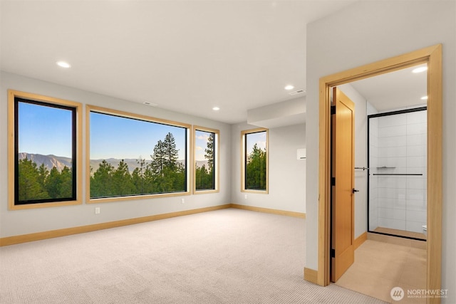 unfurnished bedroom featuring carpet floors, recessed lighting, and multiple windows
