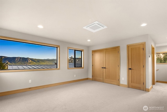unfurnished bedroom featuring carpet floors, baseboards, recessed lighting, and visible vents