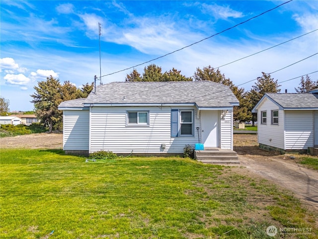 bungalow-style house with a front lawn