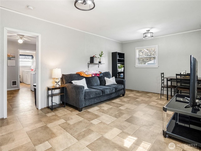 living area with crown molding, visible vents, a ceiling fan, and a wealth of natural light