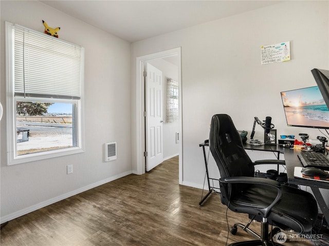 office space with baseboards, wood finished floors, and visible vents