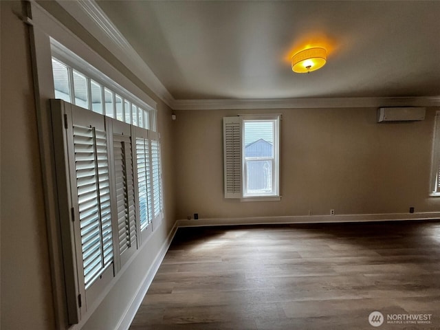 422 Chenault Ave, Hoquiam, WA 98550 - spare room with ornamental molding, a wall unit AC, wood finished floors, and a wealth of natural light